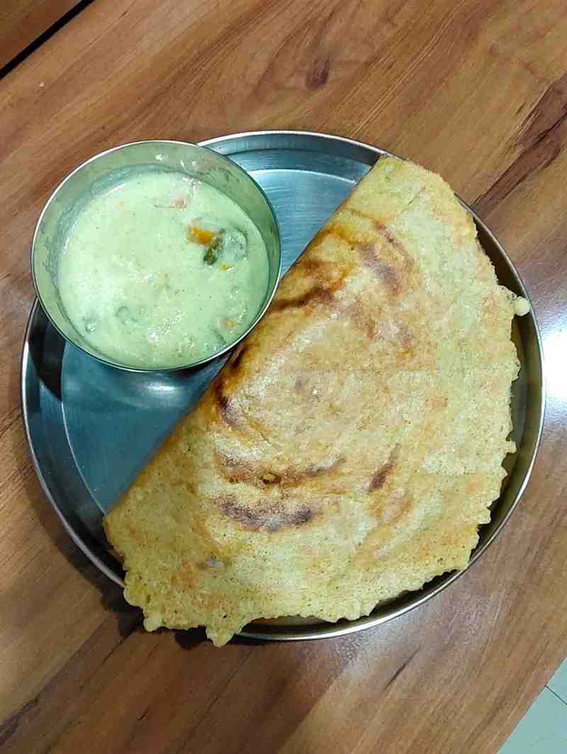 Adai is a traditional South Indian savory pancake. It's made with rice and dals and spiced with red chilies. Enjoy this delicious and nutritious dish, perfect for breakfast or a wholesome snack.