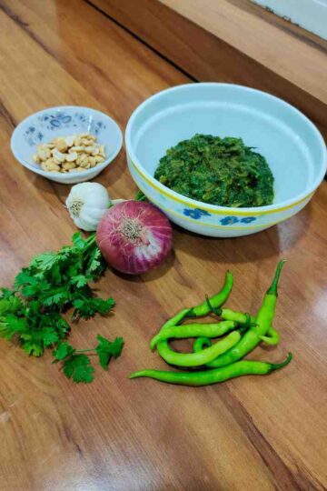 elicious Solapur Palak Bhaji served in a bowl, showcasing the vibrant green spinach and rich, nutty texture of peanuts, garnished with fresh coriander leaves.