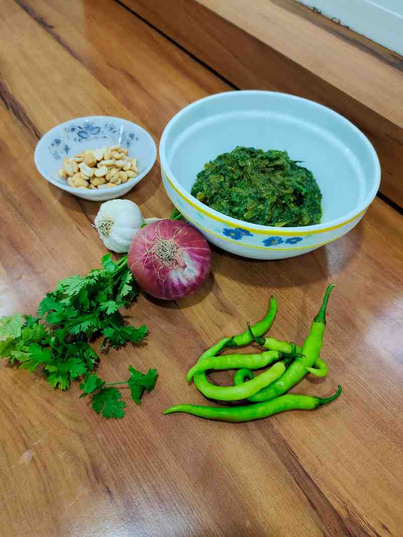 elicious Solapur Palak Bhaji served in a bowl, showcasing the vibrant green spinach and rich, nutty texture of peanuts, garnished with fresh coriander leaves.