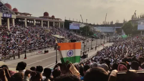 Crowd waving the tricolour at the Wagah border ceremony