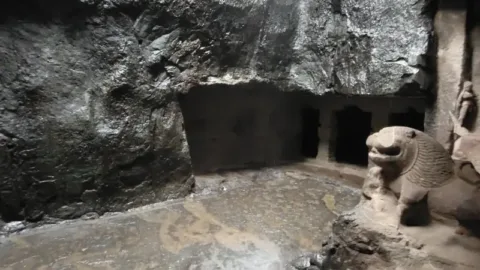 Stone lion guarding Cave 29 at Ellora