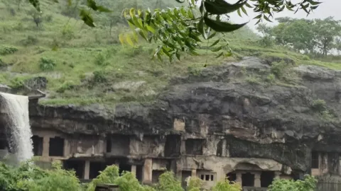Ellora Caves cliff with a monsoon waterfall