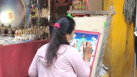 Artist painting a thangka in McLeodganj