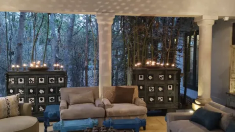 Candle-lit forest lounge at dusk near Pench