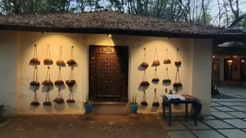 Jungle lodge entrance lit up at dusk near Pench